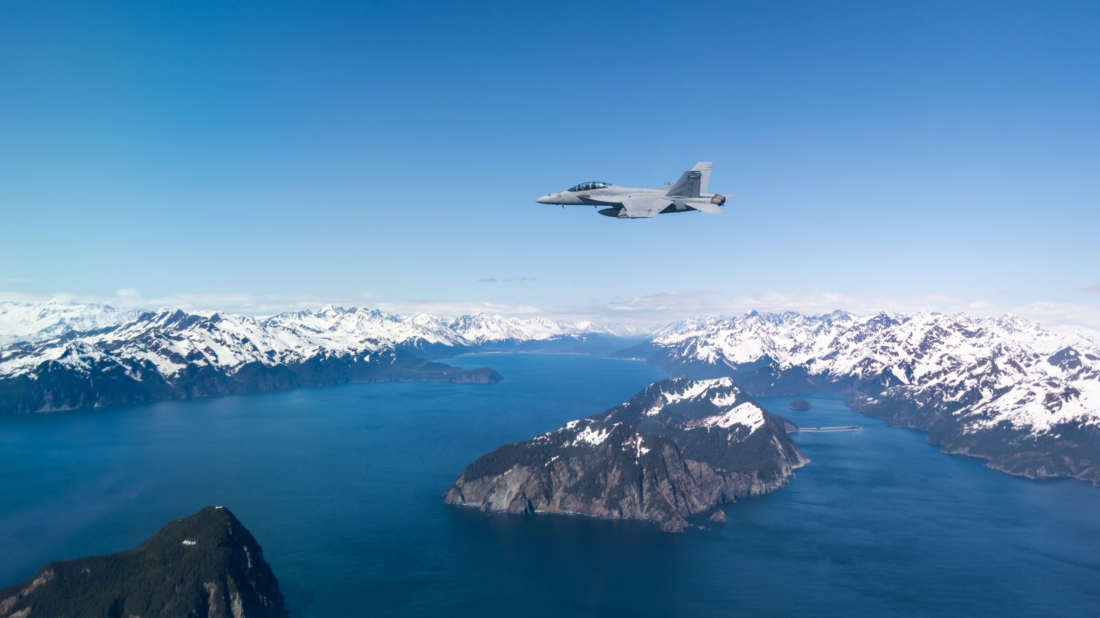 F/A-18F Super Hornet flying over mountains in Alaska